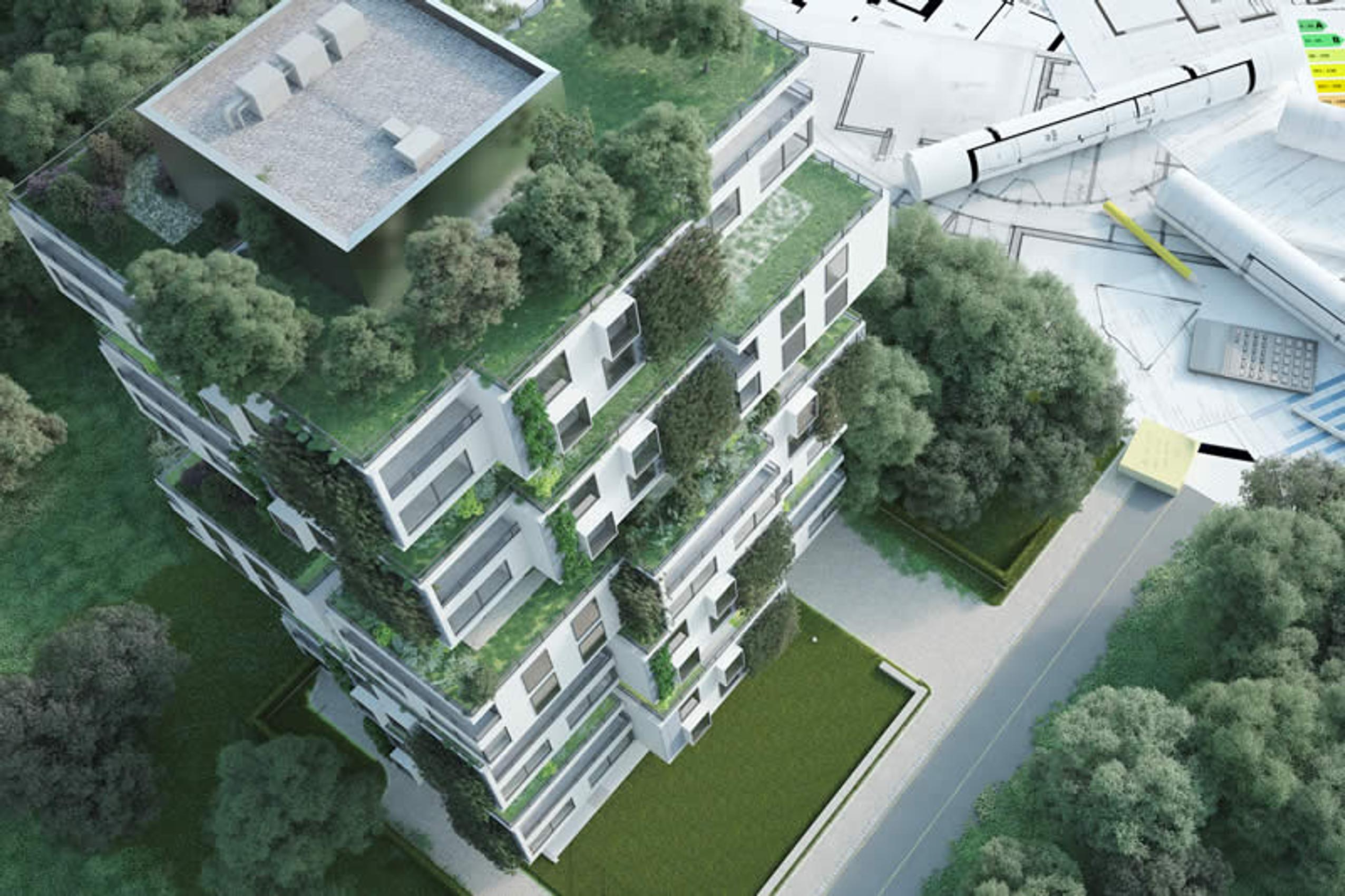 Bildquelle: shutterstock.com/Franck Boston Modell eines Mehrparteienhauses mit Dach- und Fassadenbegrünung neben Planungsunterlagen